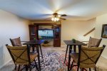 Fully finished and furnished basement w/ pool table, gathering area, and HDTV